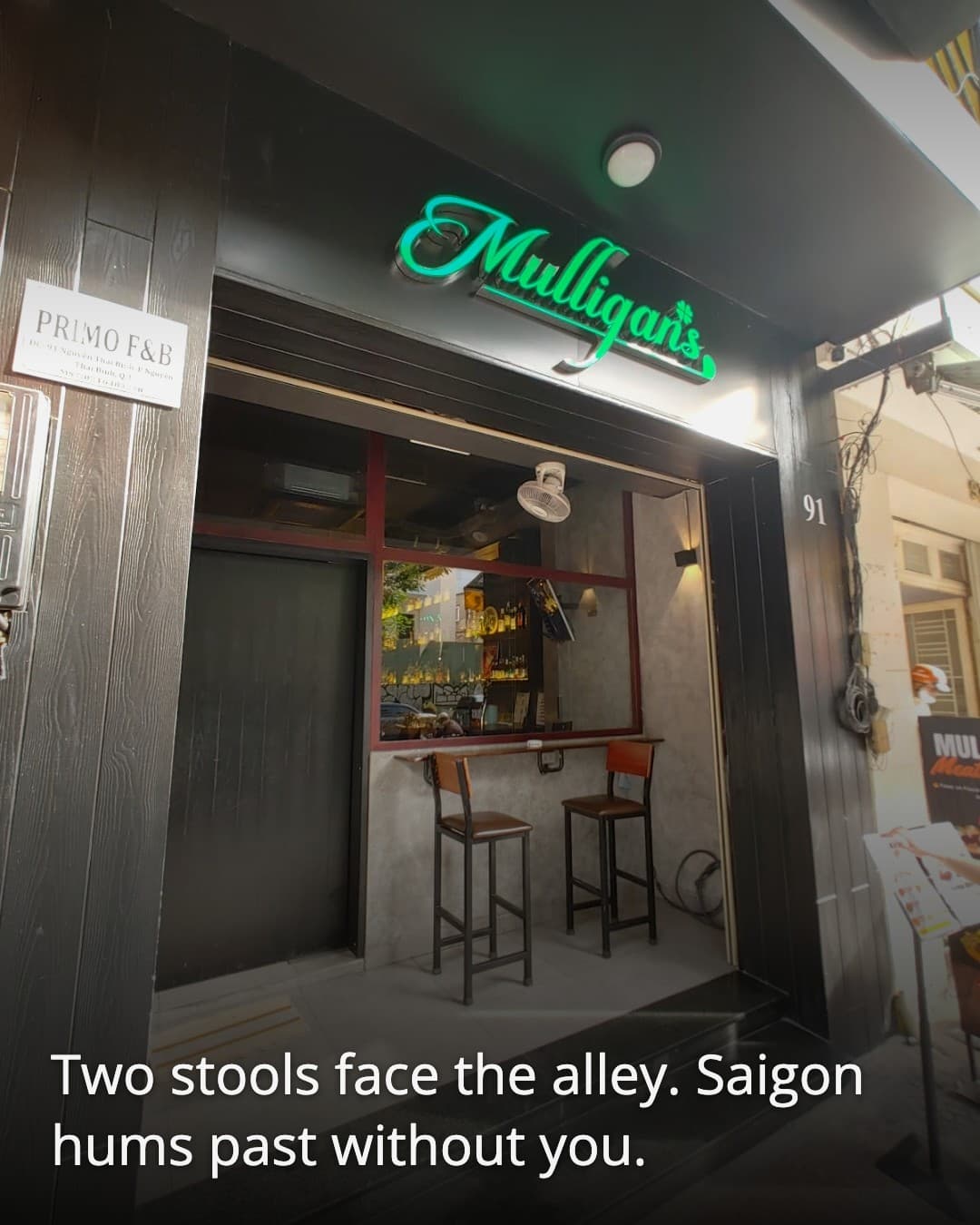 Mulligans Saigon bar stools facing the alley