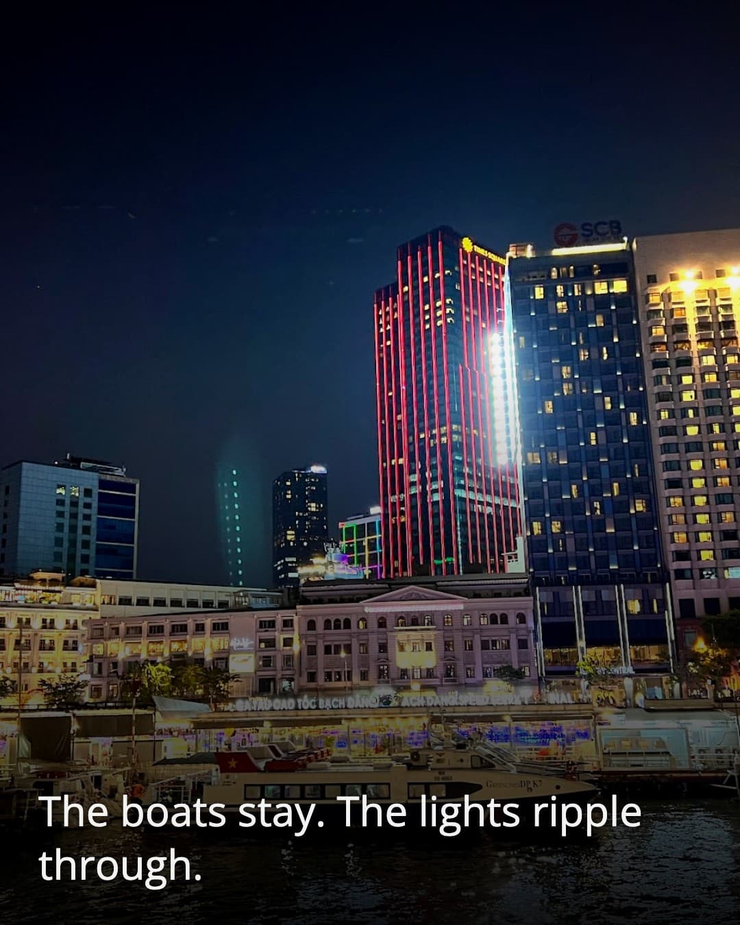 Riverside Park at night with boats at the dock